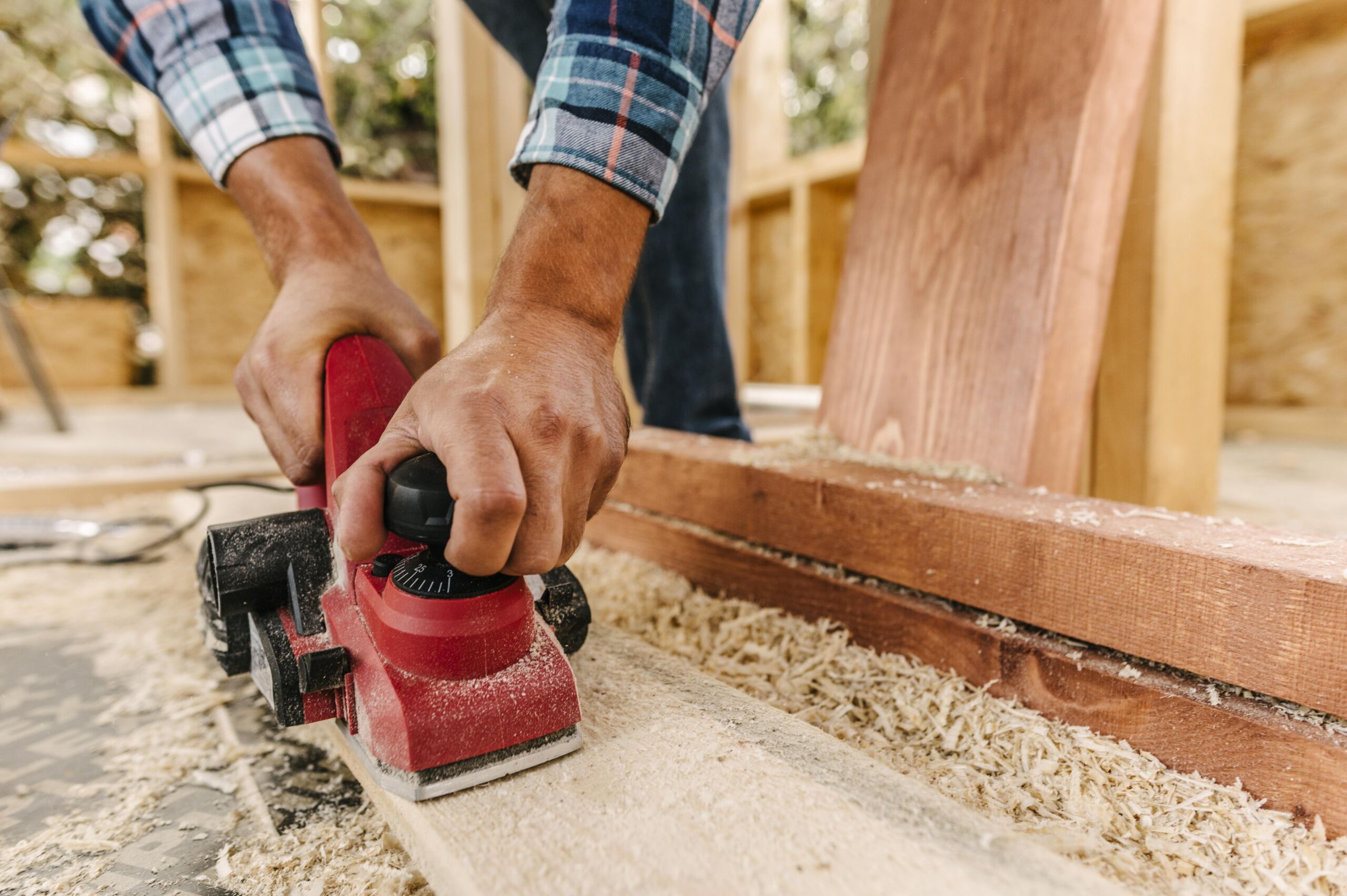 construction-worker-sanding-down-wood-piece